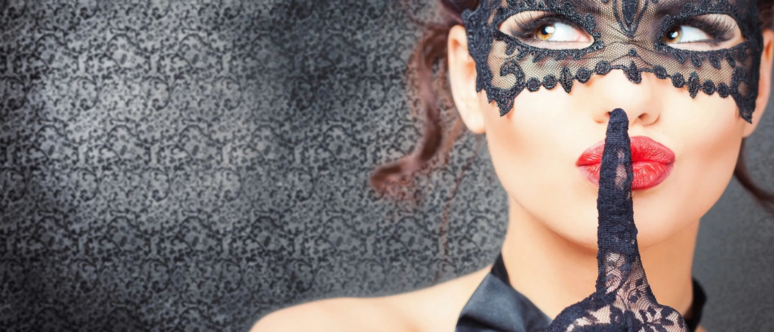 Pretty woman in a mask saying shhh